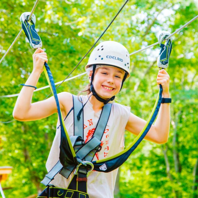 Smiling camper completes zip line