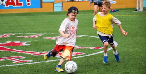 Kids playing soccer.