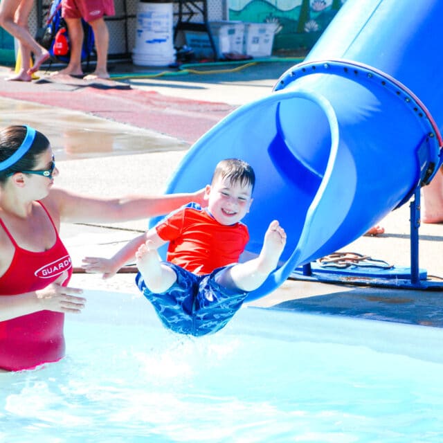 Camper coming down a water slide.