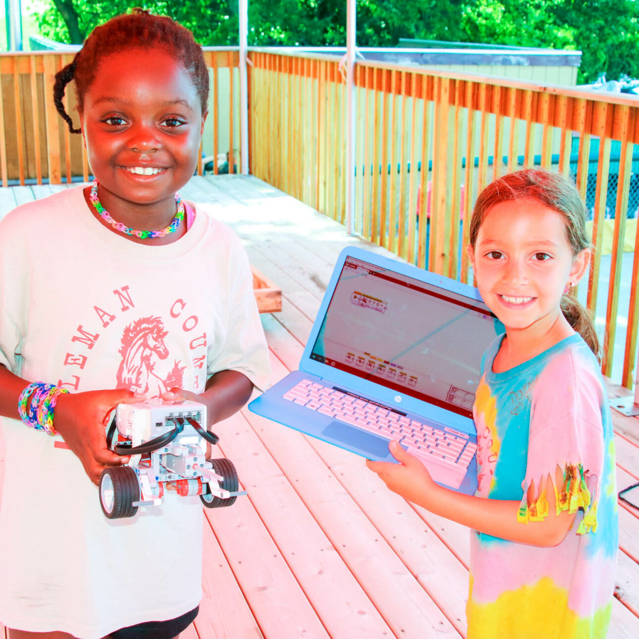 Campers with a robot and a laptop.