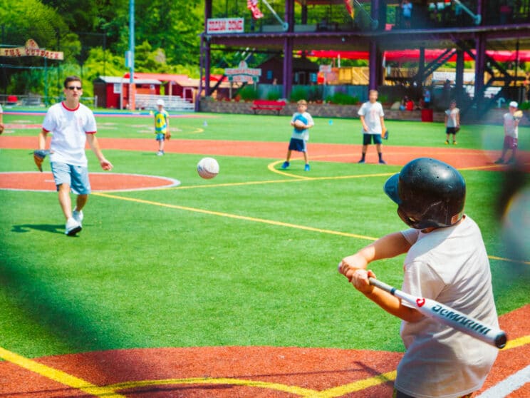 Boy camper about to hit a baseball.