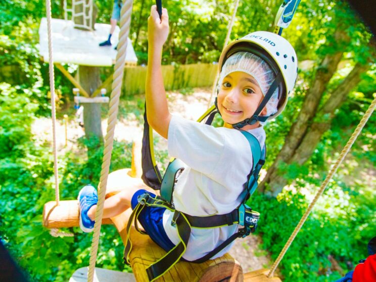 Boy smiles at beginning of challenge course