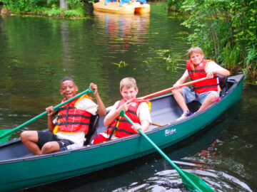 Three boys in a canoe.
