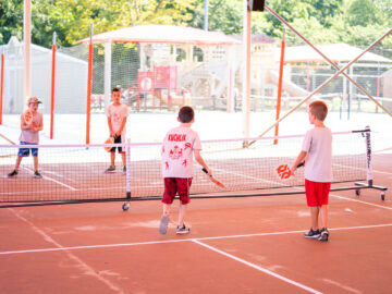 Campers playing pickleball.