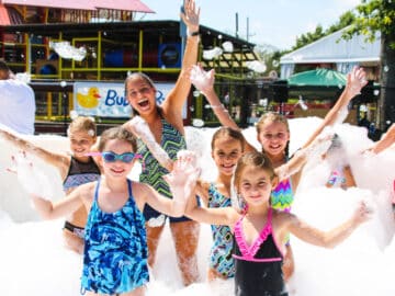 Group cheers while covered in bubbles