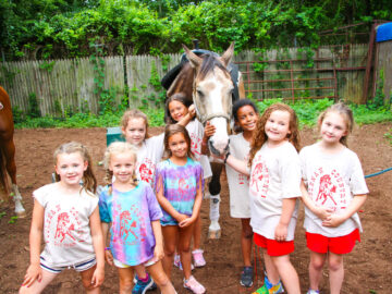Group of campers with a horse.