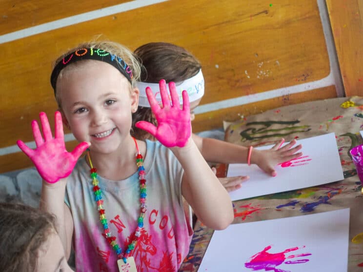 Camper painting with her hands.