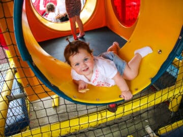 PIT camper playing in a play structure.