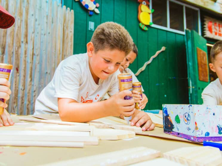 Camper applies wood glue to woodworking project