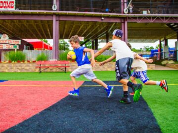 Campers run across field during game