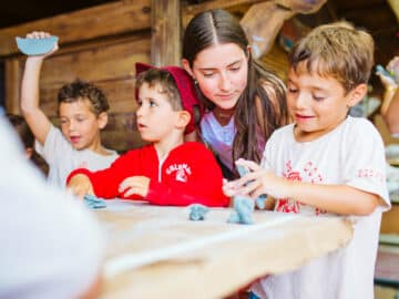 Young campers work with clay