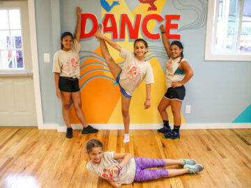 Campers posing in front of the "Dance" wall.
