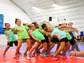 Campers lean backward during group dance