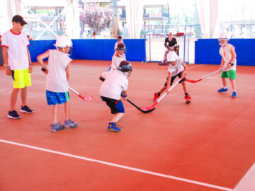Campers playing indoor hockey.