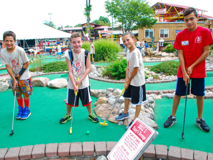 Campers playing mini golf.
