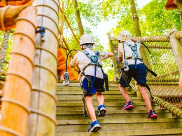 Campers climb stairs up to challenge course