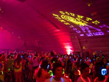 Campers dancing in the dome with pink lights