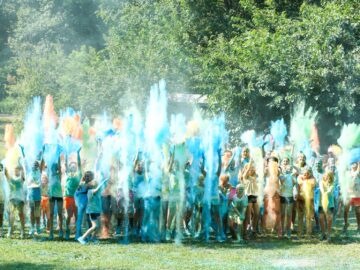 Campers throwing color chalk from the run into the air