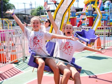 Campers cheer while on fair ride