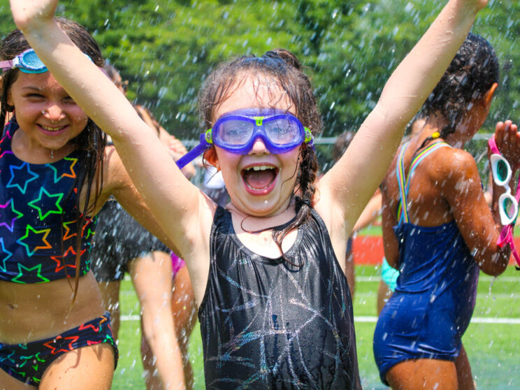 Girl with goggles on enjoying field day.