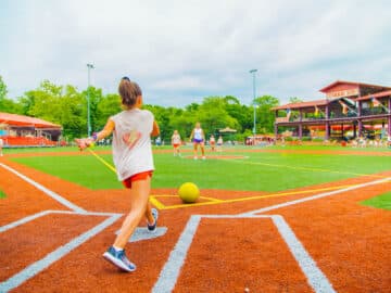 Girl about to kick a kick ball.