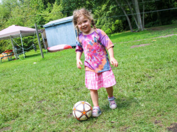 Young girl with a soccer ball.