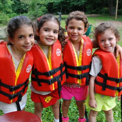 Four Pioneer campers in life vests.