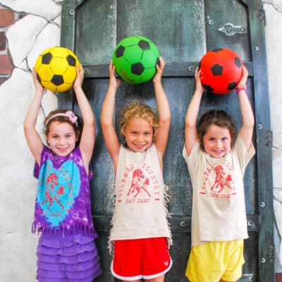 Three Scout campers holding soccer balls.