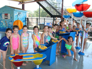 Group of campers playing with aquatic toys.