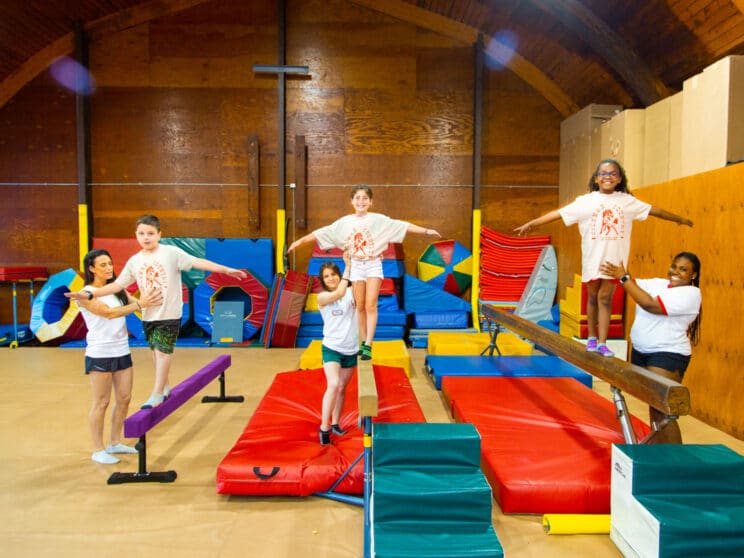 Campers learning gymnastics