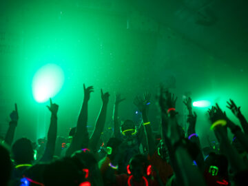 Hands up in the dome, dancing with green lights all around
