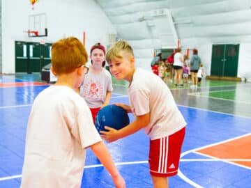 Boys playing indoor basketball