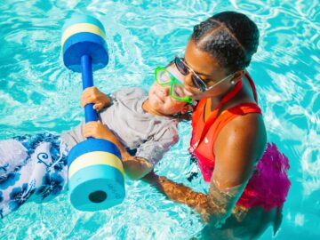 Swim instructor uses pool weight to teach young camper