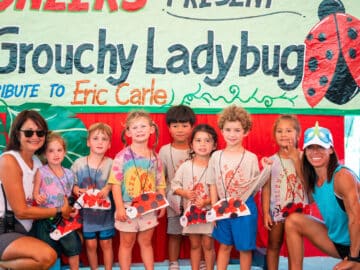 Group of campers with lady bug crafts.