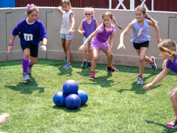 Campers dressed in purple playing a game.