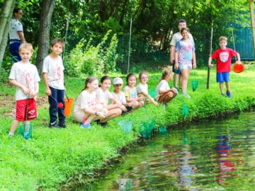 Group of campers hanging out by the water.