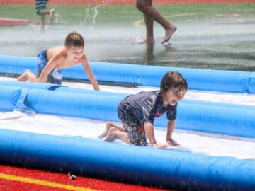 Two campers ride down slip 'n' slide