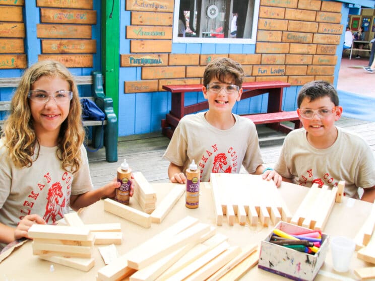 Campers working on wood working project at camp