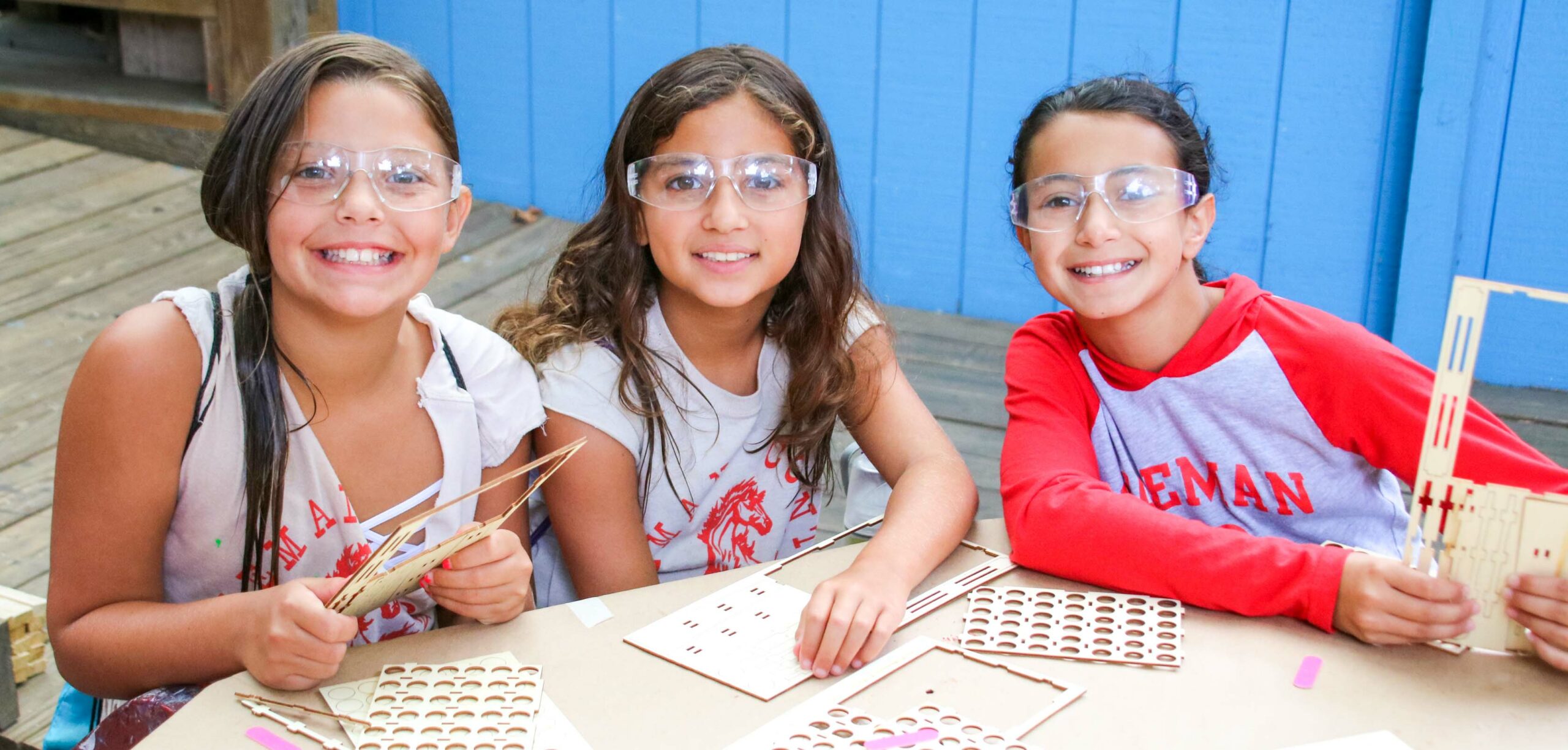 Three girl campers working on a STEM project