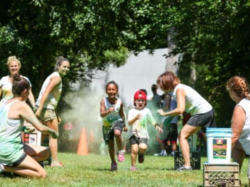 A couple of campers running in the color run