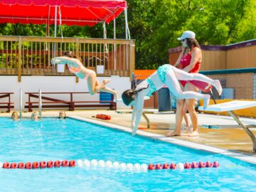 Two campers dive into pool