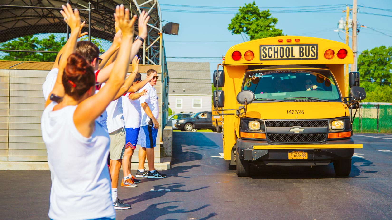 Counselors cheer as bus arrives