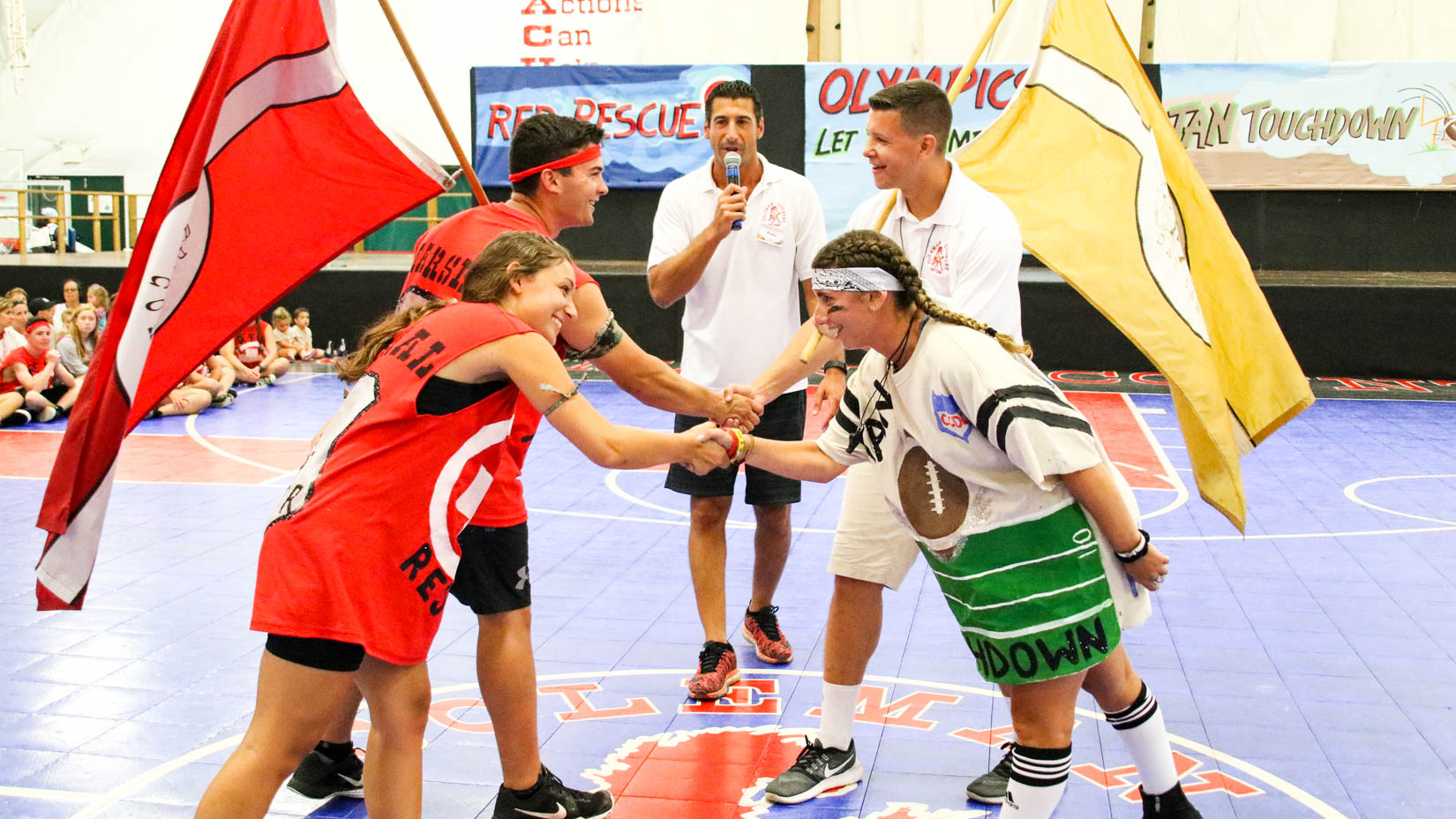 Opposing sides of camp Olympics shake hands