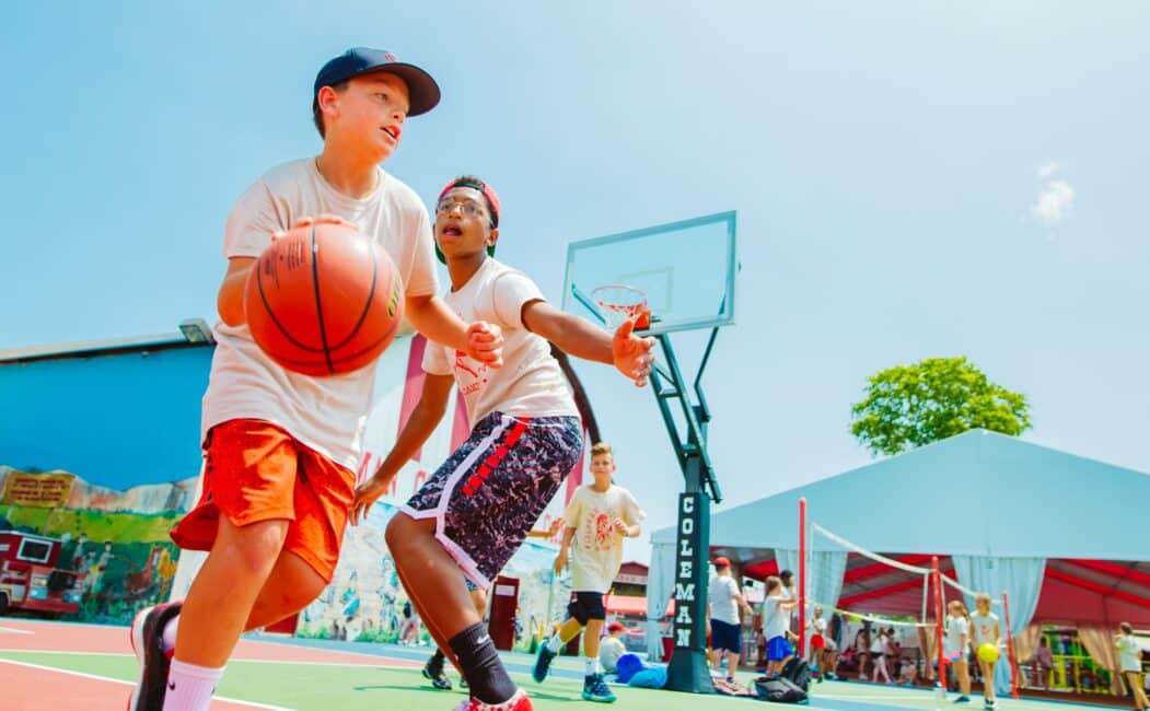 Two campers play basketball