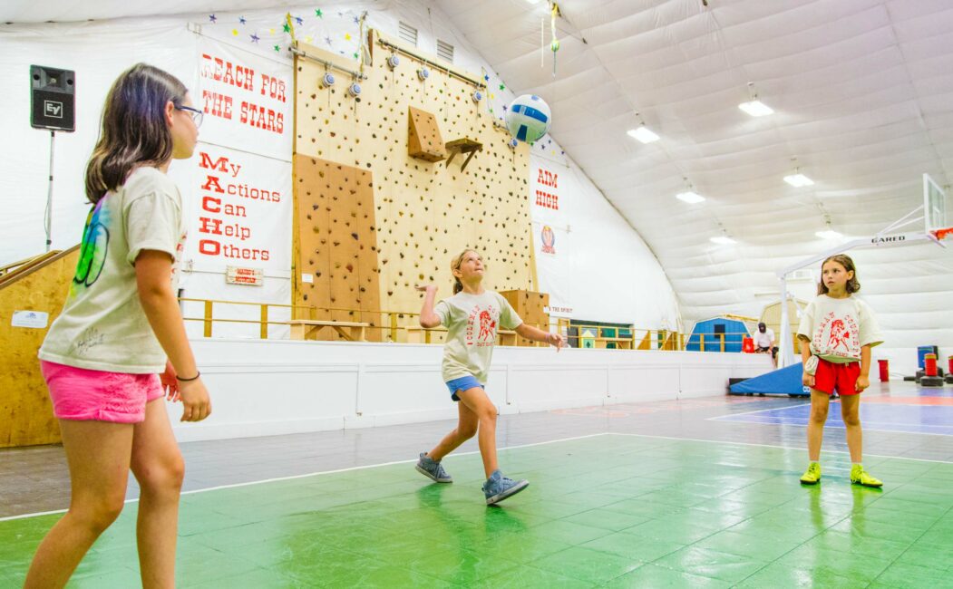 Campers play indoor volleyball