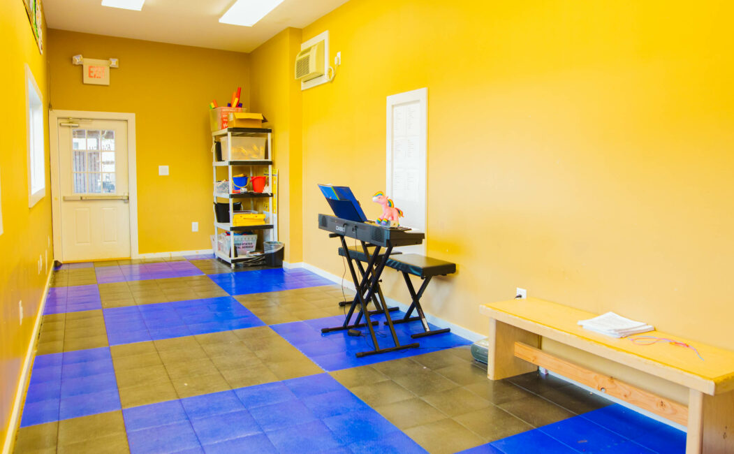 Piano room with yellow walls and blue checkered floor