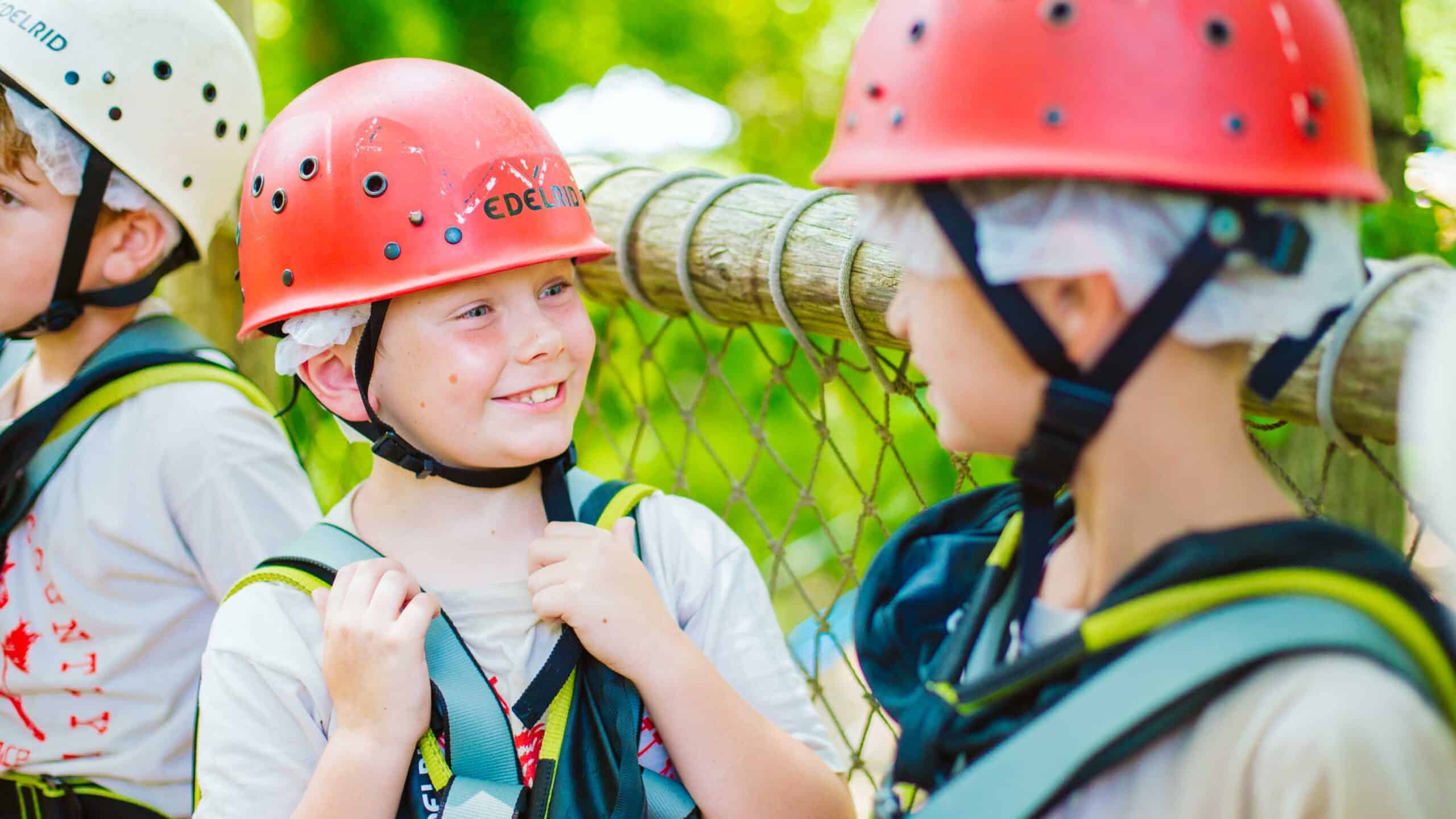 Smiling boy wearing gear for challenge course