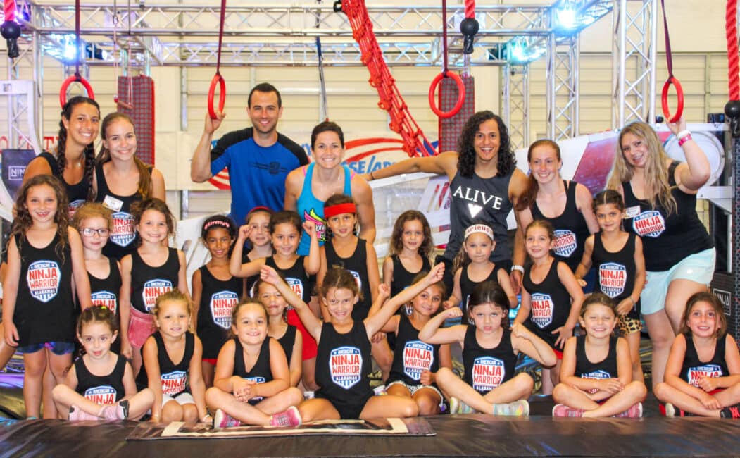 American Ninja Warrior's Daniel Gil, Joe Moravsky, and Flex Labrek with group of girl campers