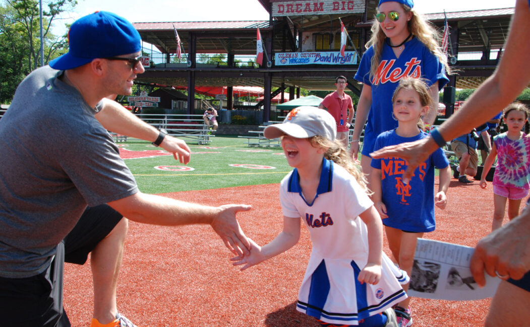 David Wright high fiving a young camper in mets gear