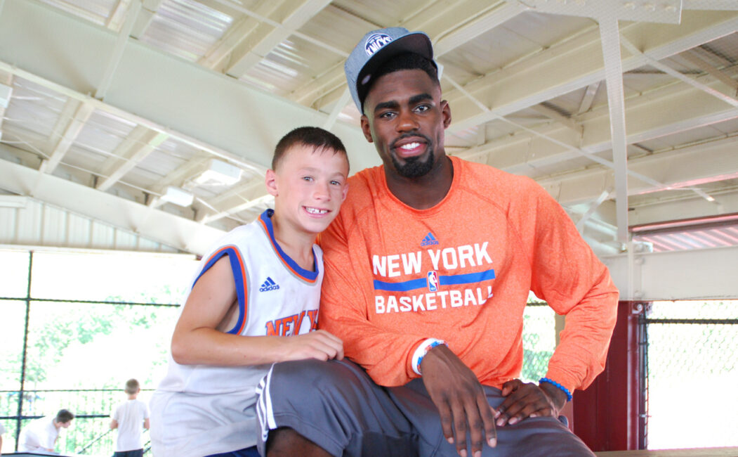 Tim Hardaway Jr with a young camper
